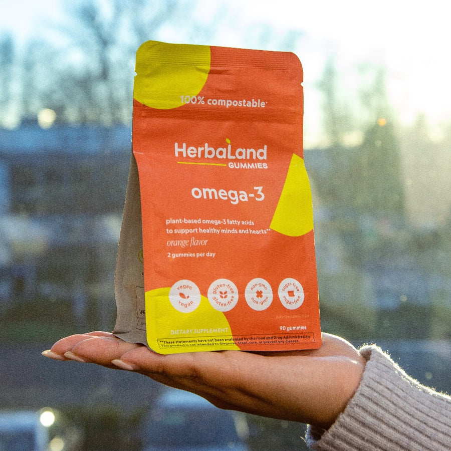 A picture of a pouch of herbaland omega 3 gummies to support healthy minds and hearts with orange flavor 
